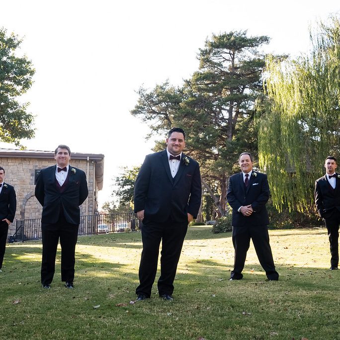 Hall exterior groomsmen on open field